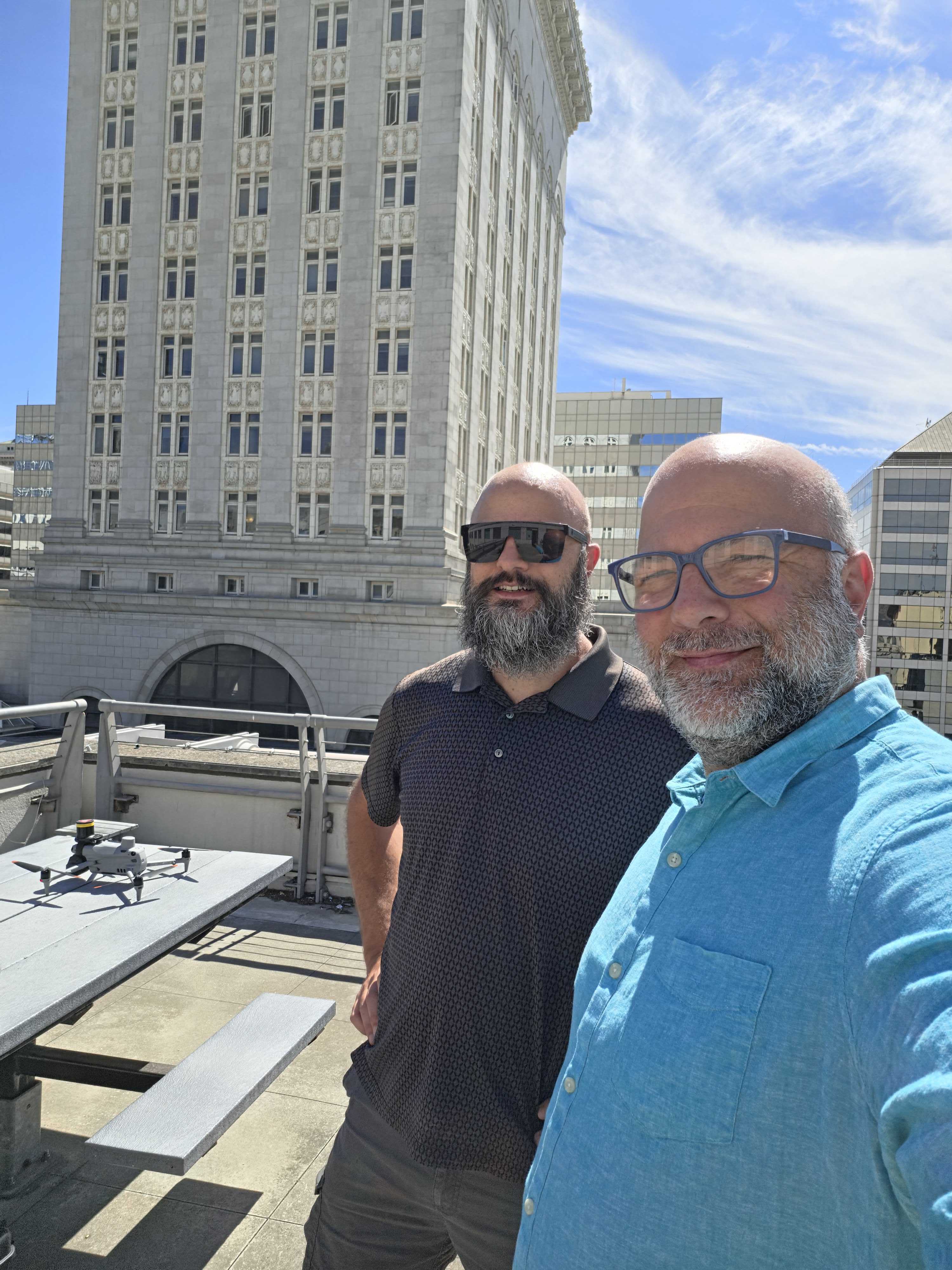 FAA Part 107 certified pilot operating the mapping drone from a downtown Oakland rooftop