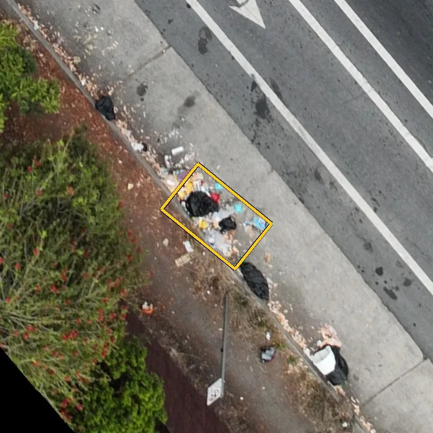 Close aerial view of the new pile with a yellow bounding box drawn around it by the detection model